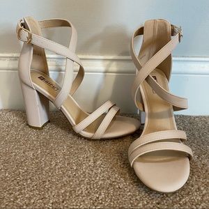 womens tan four inch heels with ankle details.